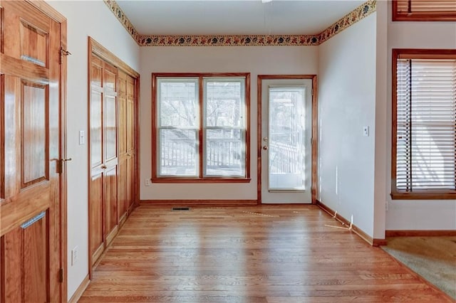 doorway to outside with light hardwood / wood-style floors