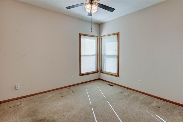 carpeted spare room with ceiling fan