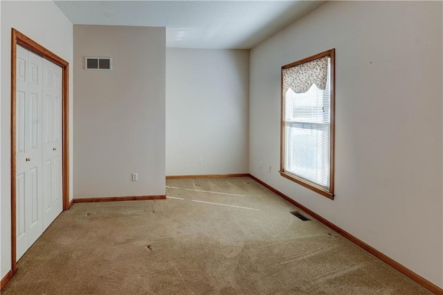 unfurnished room with light colored carpet