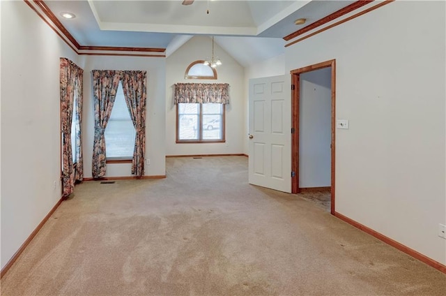 carpeted spare room with lofted ceiling and a notable chandelier