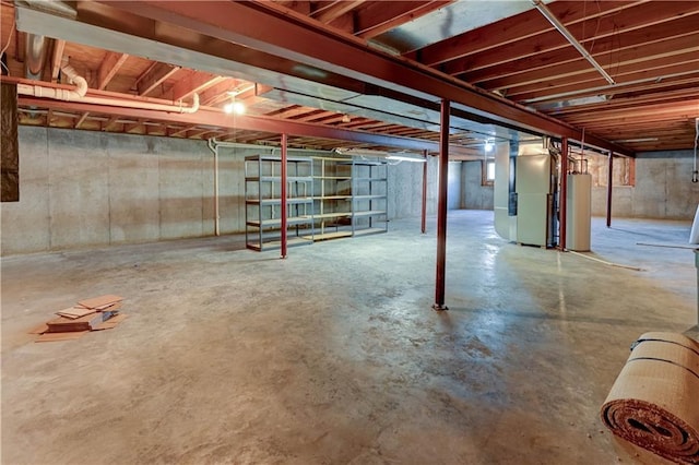 basement featuring heating unit and water heater