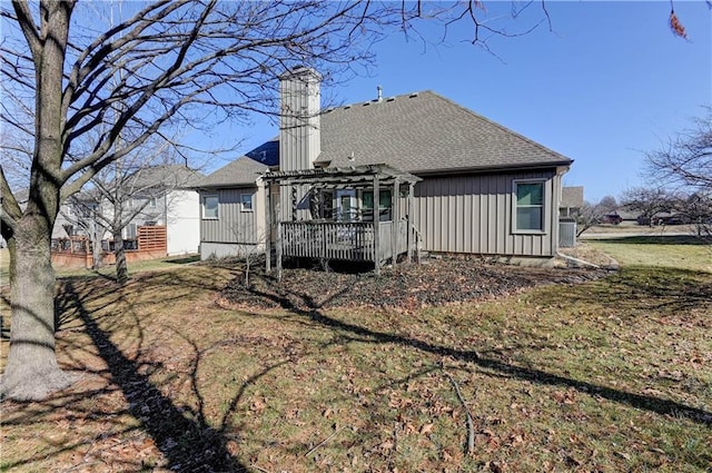 rear view of property with cooling unit, a yard, a pergola, and a deck