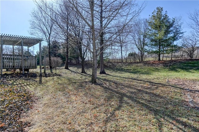 view of yard with a pergola and a deck