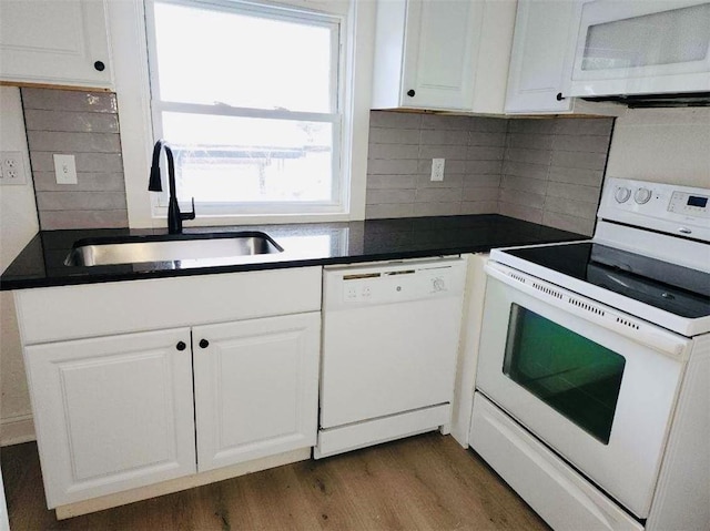 kitchen with white cabinetry, sink, backsplash, dark hardwood / wood-style flooring, and white appliances