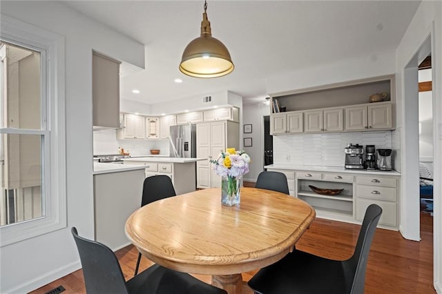 dining space featuring dark wood-type flooring