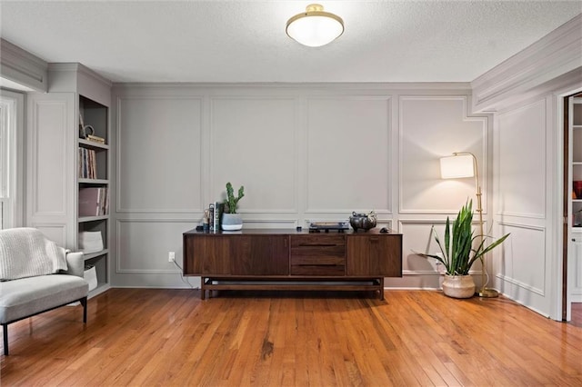 office area with built in features and light hardwood / wood-style flooring