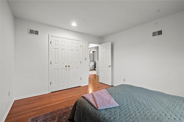 bedroom featuring hardwood / wood-style floors and a closet