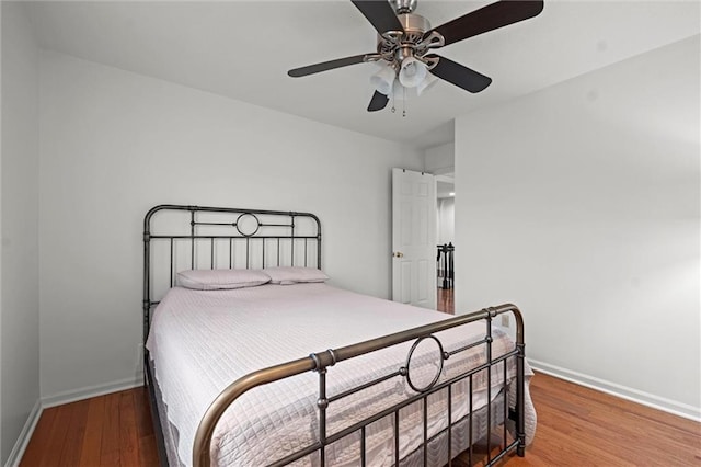 bedroom with ceiling fan and wood-type flooring