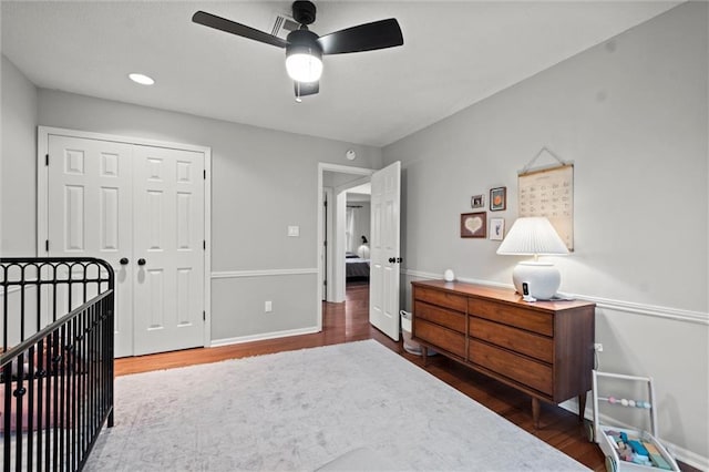 bedroom featuring dark hardwood / wood-style flooring, a closet, and ceiling fan