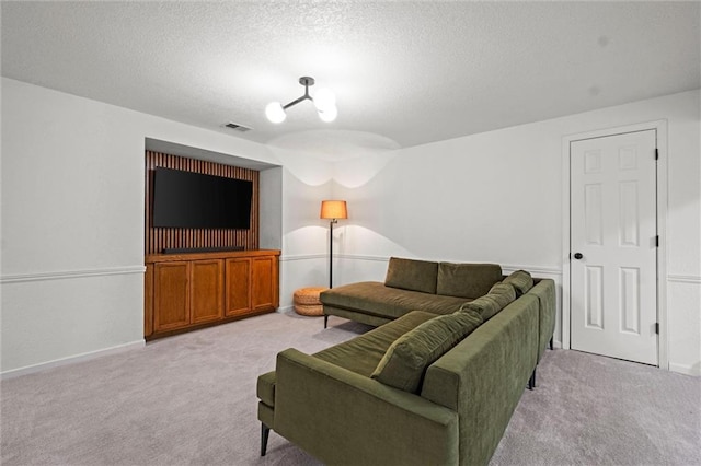 carpeted living room with a textured ceiling