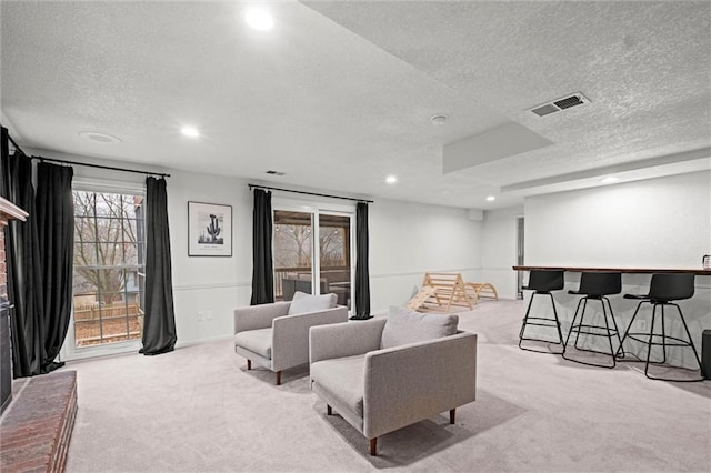 home theater featuring light carpet and a textured ceiling