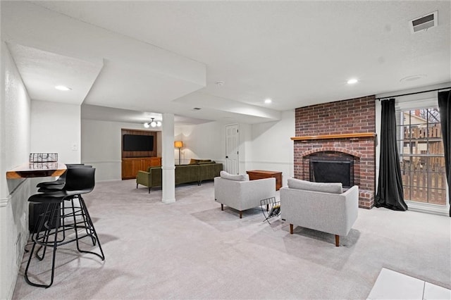 carpeted living room with a fireplace