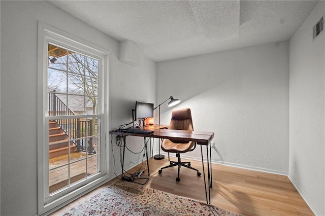 office featuring hardwood / wood-style flooring and a textured ceiling