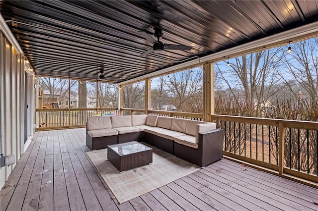 wooden deck featuring ceiling fan and an outdoor living space