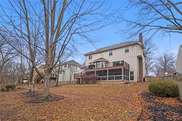 back of property with a sunroom