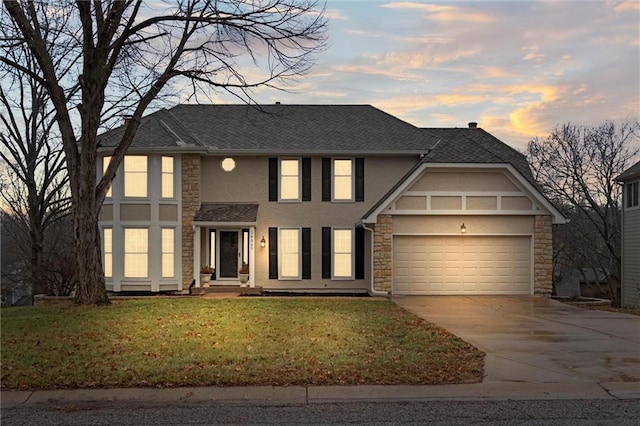 view of front of property with a yard and a garage