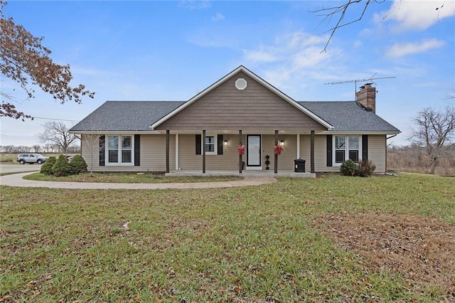 ranch-style house with covered porch and a front lawn