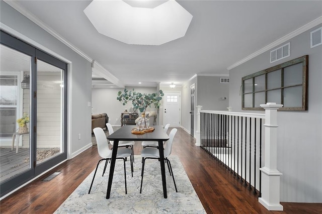 dining room with crown molding and dark wood-type flooring