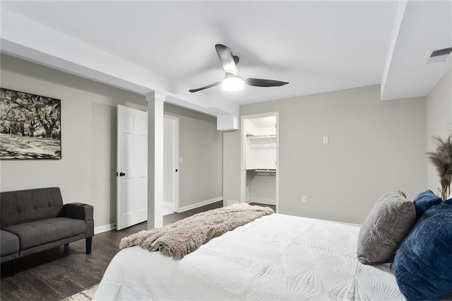 bedroom featuring a spacious closet, hardwood / wood-style floors, ceiling fan, and a closet