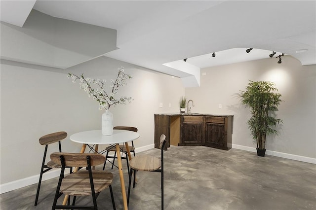 dining room with concrete flooring and sink