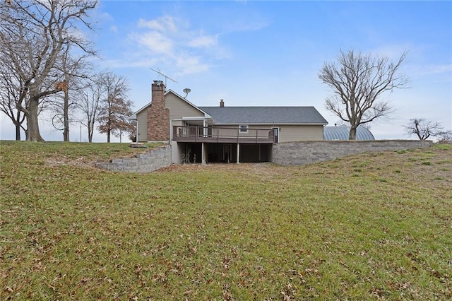 back of house featuring a yard and a deck