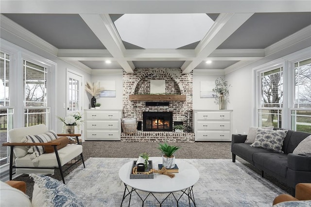 carpeted living room with coffered ceiling, beam ceiling, a brick fireplace, and crown molding