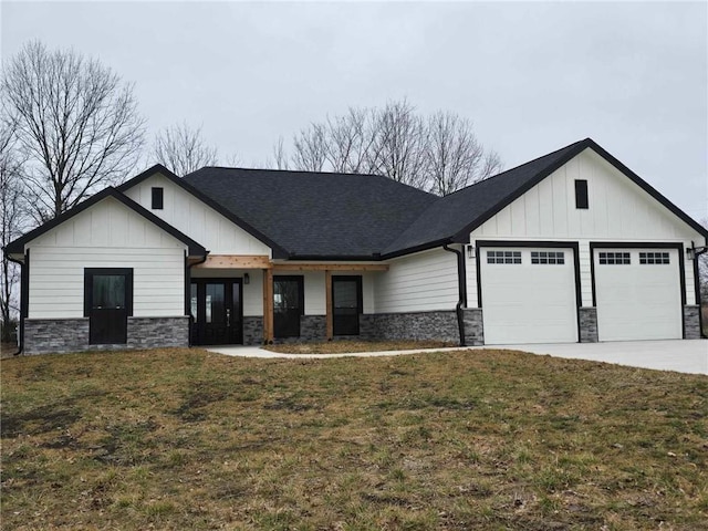 modern farmhouse featuring a garage and a front lawn