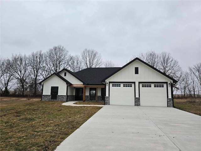 modern inspired farmhouse with a garage and a front lawn