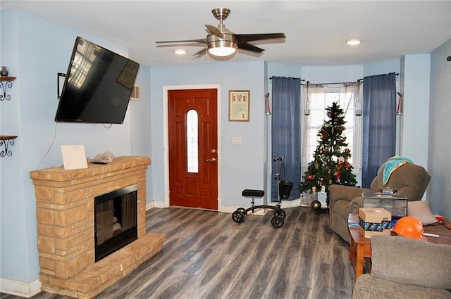 living room with dark hardwood / wood-style flooring and ceiling fan