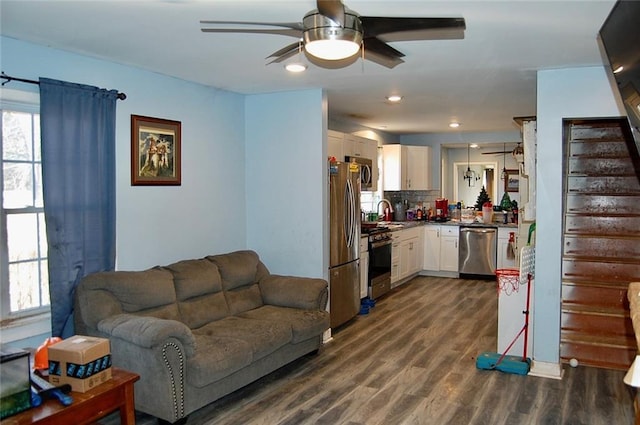 living room with ceiling fan and dark hardwood / wood-style floors