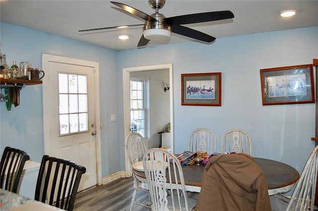 dining space with dark hardwood / wood-style floors and ceiling fan