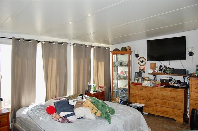 bedroom with dark hardwood / wood-style flooring