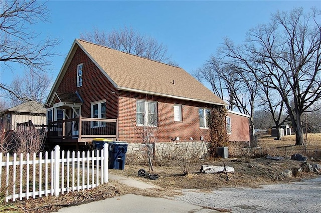 view of side of home with a wooden deck