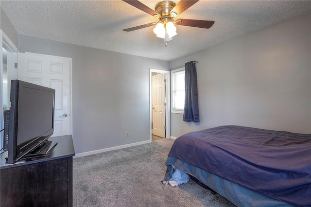 carpeted bedroom featuring ceiling fan, baseboards, and a textured ceiling