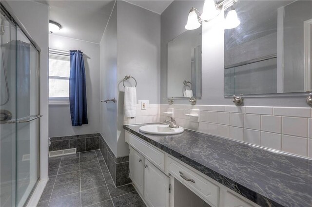 bathroom featuring decorative backsplash, a shower stall, vanity, and tile patterned floors