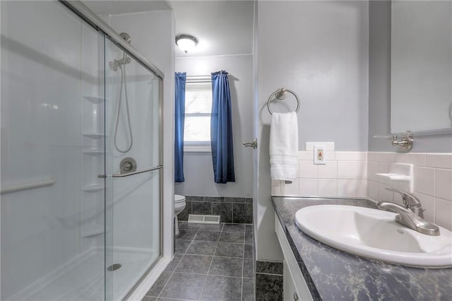 full bathroom featuring visible vents, a shower stall, and vanity