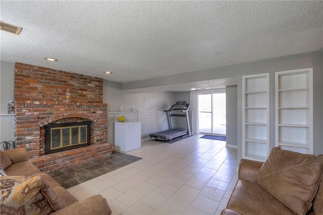 unfurnished living room with built in features, a fireplace, recessed lighting, visible vents, and a textured ceiling