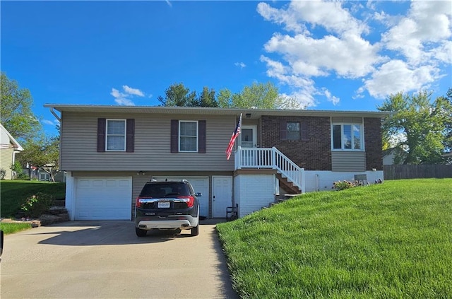 view of front of home featuring a garage and a front yard