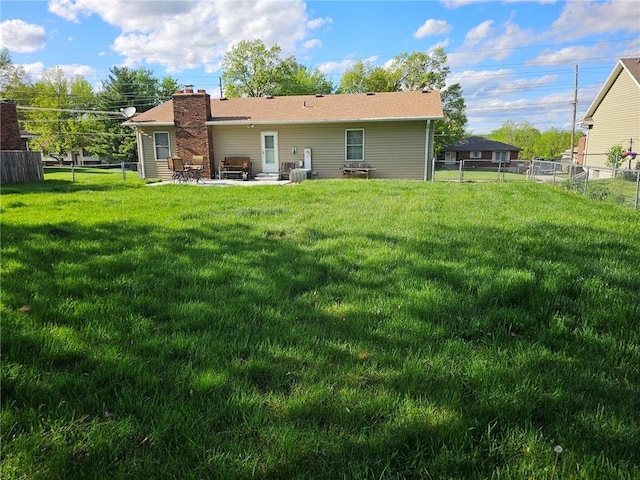 rear view of house with a yard, cooling unit, and a patio area