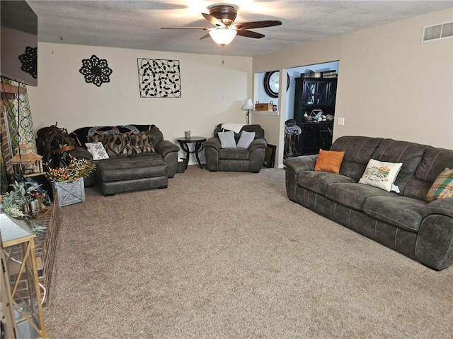 carpeted living room with a textured ceiling and ceiling fan