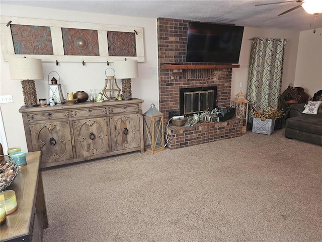 living room with ceiling fan, carpet, a textured ceiling, and a fireplace