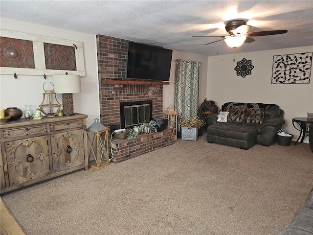 living room featuring ceiling fan, carpet floors, a textured ceiling, and a fireplace