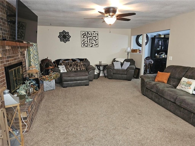 living room featuring a brick fireplace, carpet floors, a textured ceiling, and ceiling fan