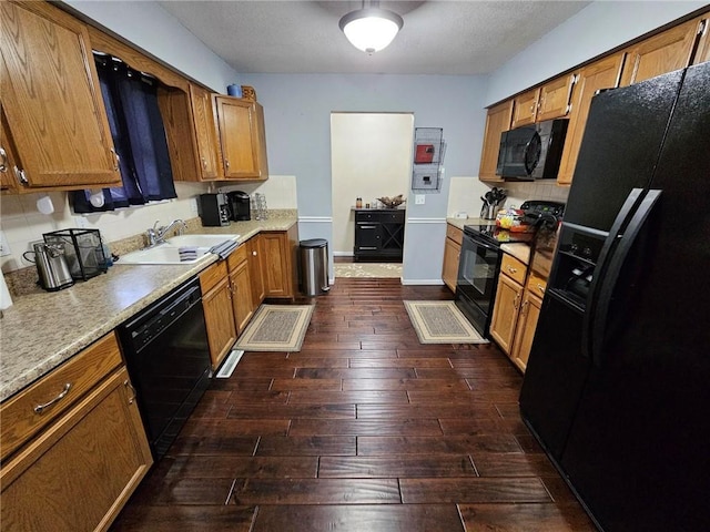 kitchen with dark wood-type flooring, sink, and black appliances