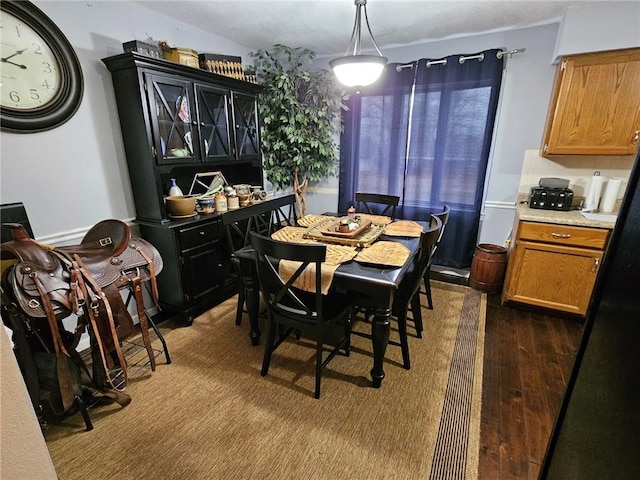 dining space with dark wood-type flooring