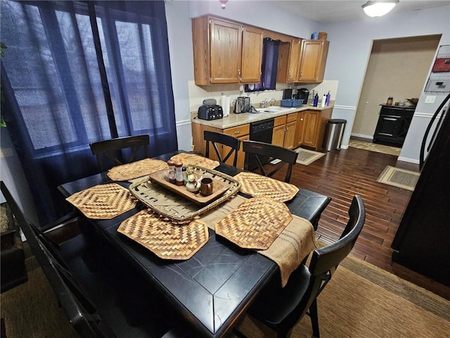 dining room with sink and dark wood-type flooring