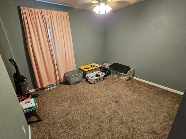 misc room with ceiling fan and carpet