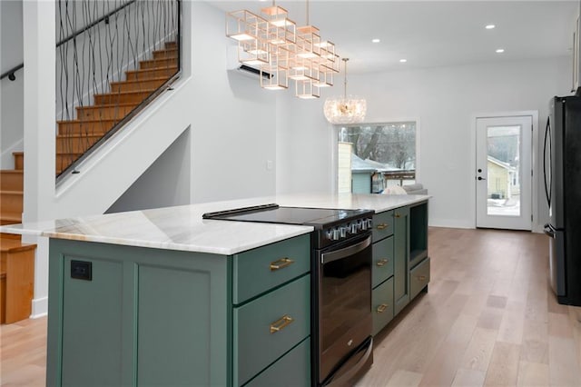 kitchen featuring electric range oven, green cabinets, freestanding refrigerator, a center island, and pendant lighting