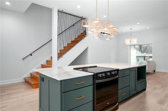 kitchen with light wood-style flooring, electric range, green cabinets, and a center island