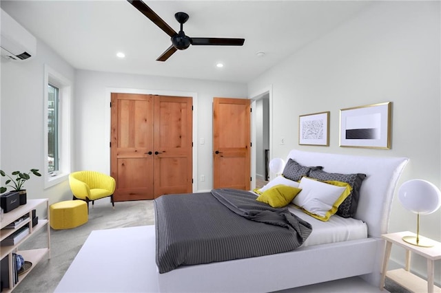 bedroom featuring recessed lighting, a closet, an AC wall unit, light carpet, and ceiling fan